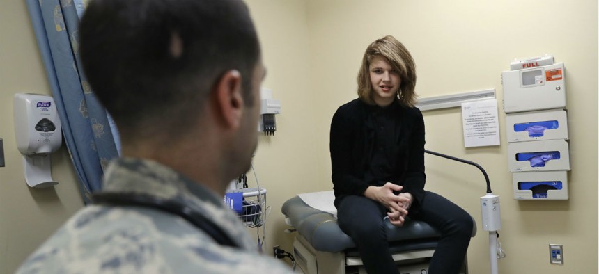 Dr. David Klein, an Air Force Major and chief of adolescent medicine at Fort Belvoir Community Hospital, left, speaks with Jenn Brewer, 13, during an appointment in September 2016.