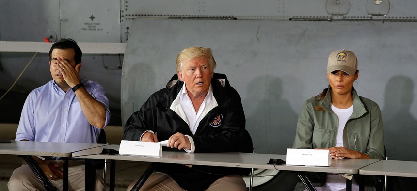 Puerto Rico Gov. Ricardo Rosselló, President Donald Trump and First Lady Melania Trump speak at Luis Muniz Air National Guard Base Tuesday.