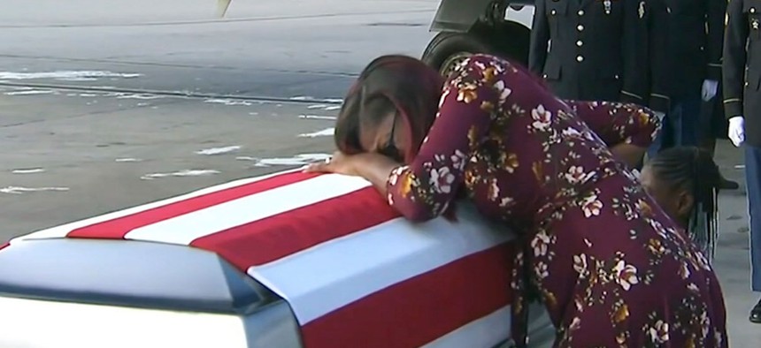 Myeshia Johnson cries over the casket of her husband, Sgt. La David Johnson, who was killed in an ambush in Niger, upon his body's arrival in Miami. 