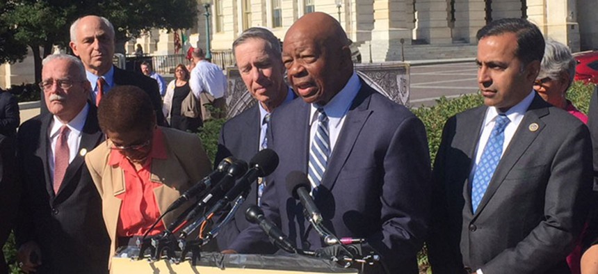 Rep. Elijah Cummings, D-Md. (center at microphones), said: "This lawsuit is not just about a hotel in Washington D.C. This is about the president defying a federal statute."