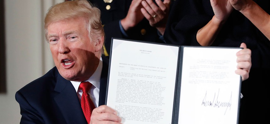 Donald Trump displays a presidential memorandum he signed, declaring the opioid crisis a public health emergency in October.