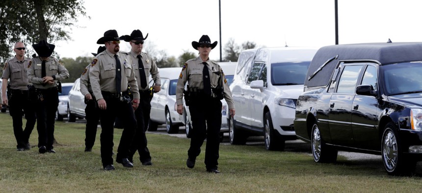 Mourners arrive at a funeral for members of the Holcombe family who were killed when an Air Force veteran with a violent history opened fire at the Sutherland Springs Baptist Church, killing 26.
