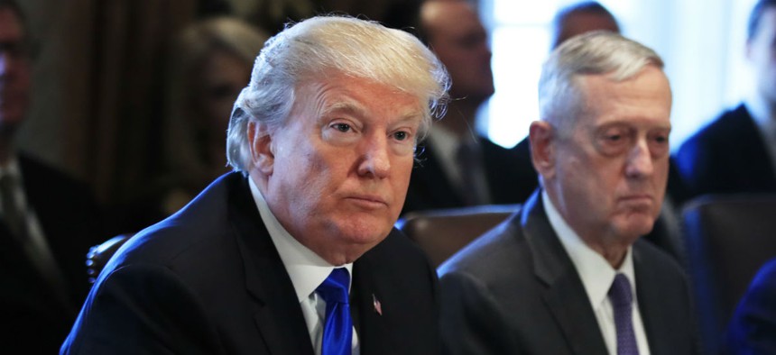 President Trump and Defense Secretary Jim Mattis (right) listen to a reporter's question during the Wednesday Cabinet meeting. 