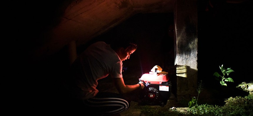 Karina Santiago Gonzalez works on a small power plant in Morovis, Puerto Rico on Dec. 21.