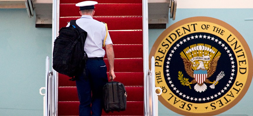 A miliary aide carries 'the football' in 2010 onto Air Force One.