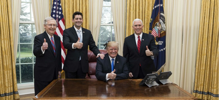 President Trump celebrates the passage of the Tax Cuts Act with Vice President Mike Pence, Senate Majority Leader Mitch McConnell, and Speaker of the House Paul Ryan on Dec. 20.