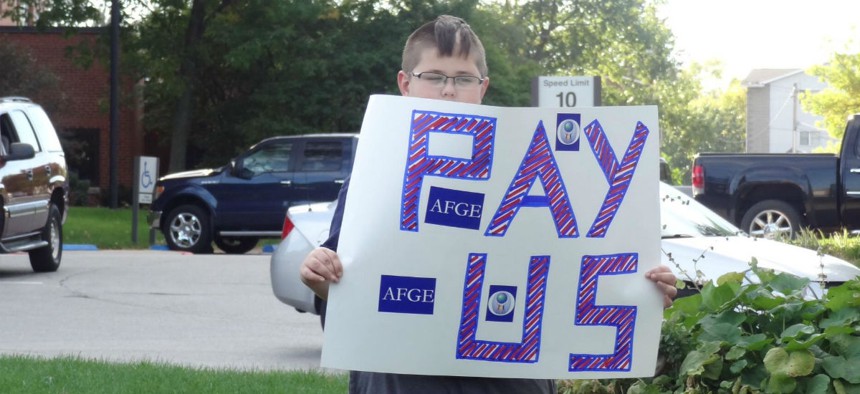An AFGE activist in Iowa protests the 2013 government shutdown. 