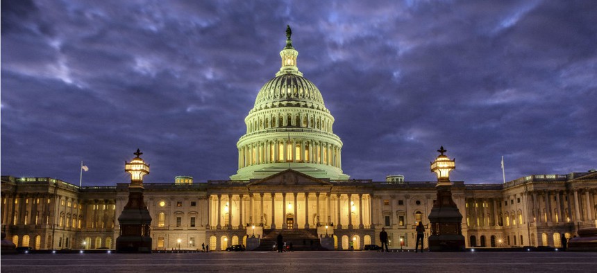 Lights shine inside the U.S. Capitol Building as night falls in Washington, Sunday, Jan. 21.