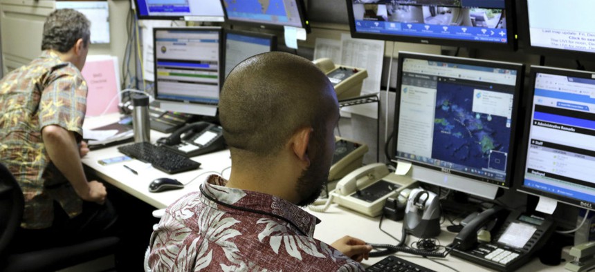 Hawaii Emergency Management Agency officials work at the department's command center in Honolulu 