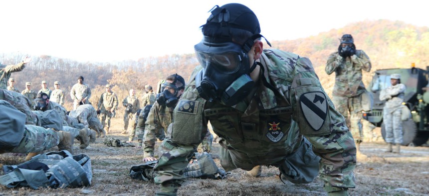 Soldiers demonstrate mission oriented protective posture (MOPP) gear change during chemical, biological, radiological and nuclear training at Camp Casey/Hovey, Republic of Korea in November. 