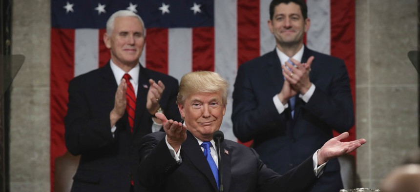 President Donald Trump gestures as delivers his first State of the Union address.