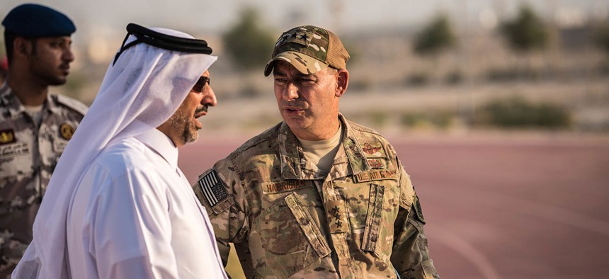 Lt. Gen. Jeffrey Harrigan, commander of the U.S. Air Forces Central Command, speaks with a Qatari Emiri Air Force leader at the QEAF Family Cultural Exchange at Al Udeid Air Base in December.