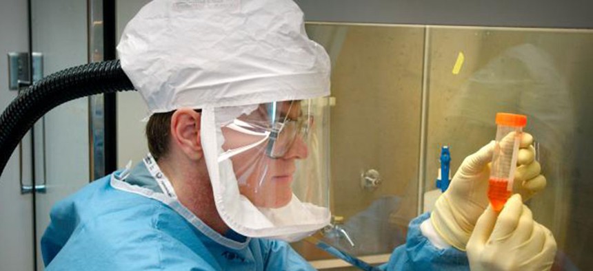 A CDC researcher examines a reconstructed 1918 pandemic flu sample in 2010.