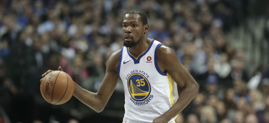 Golden State Warriors forward Kevin Durant dribbles during the first half of an NBA basketball game against the Dallas Mavericks on Jan. 3.