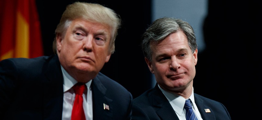 Donald Trump sits with FBI Director Christopher Wray in December.