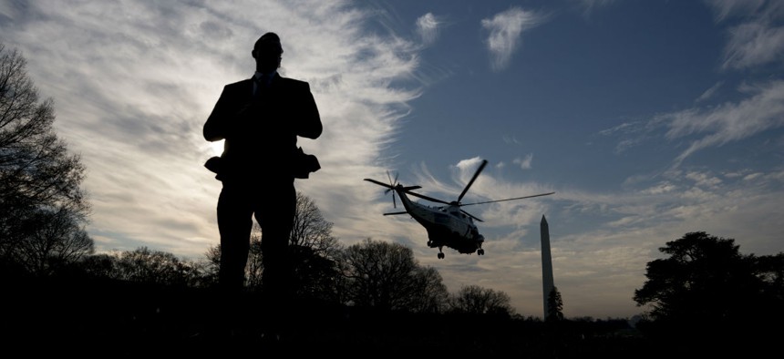 A Secret Service agent stands guard as Marine One leaves the White House. The Secret Service would see a hiring boost under Trump's budget. 
