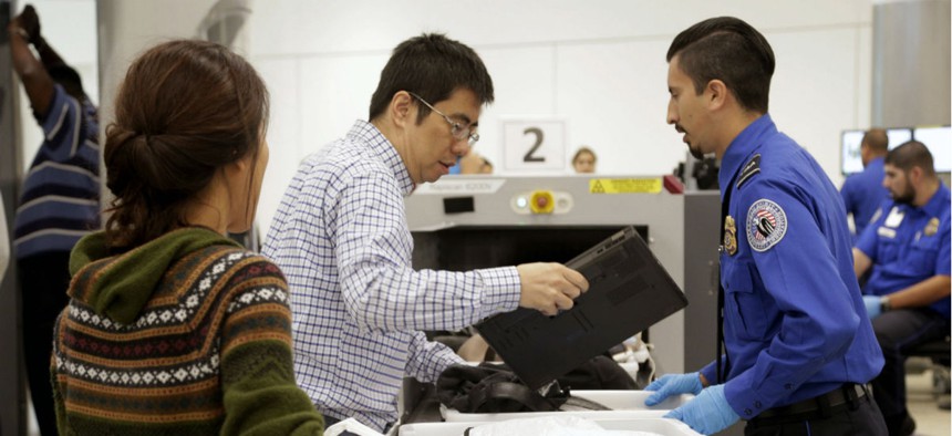Passengers from international flights pass through a TSA checkpoint at Los Angeles International Airport. 