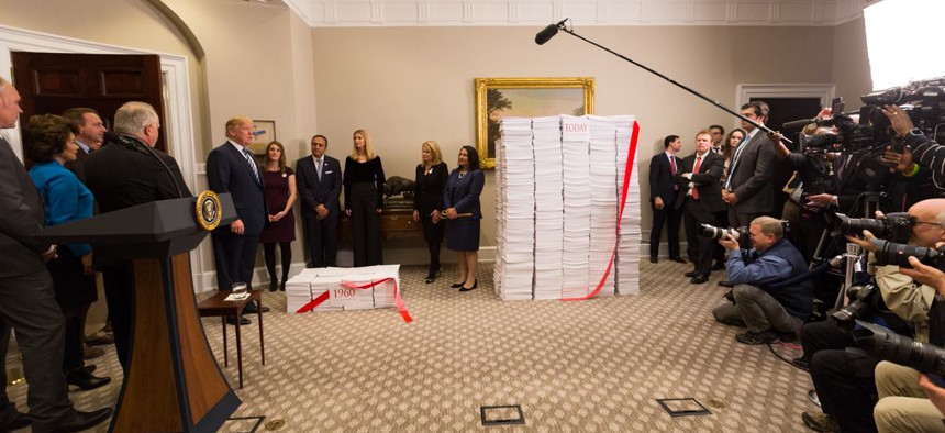 President Trump prepares to cut the “red tape” of regulations during a photo op at the White House on Dec. 14, 2017.