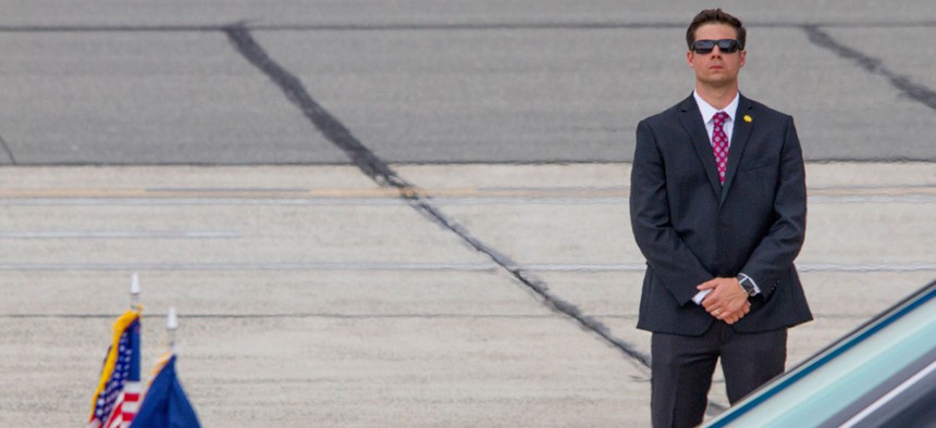 A Secret Service agent stands guard during the arrival of President Donald Trump aboard Air Force One in Ronkonkoma, New York in July.