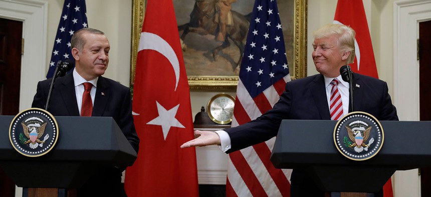 President Donald Trump, right, reaches to shake hands with Turkey's President Recep Tayyip Erdogan in 2017.