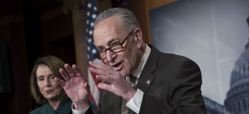 Senate Minority Leader Chuck Schumer, D-N.Y., with House Minority Leader Nancy Pelosi, D-Calif., speaks to reporters March 22 about the massive government spending bill moving through Congress.