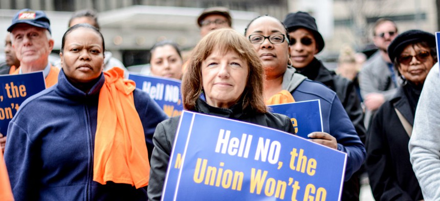 Federal union members protest the Education Department’s unilateral implementation of a new collective bargaining agreement at agency headquarters in Washington on March 28.