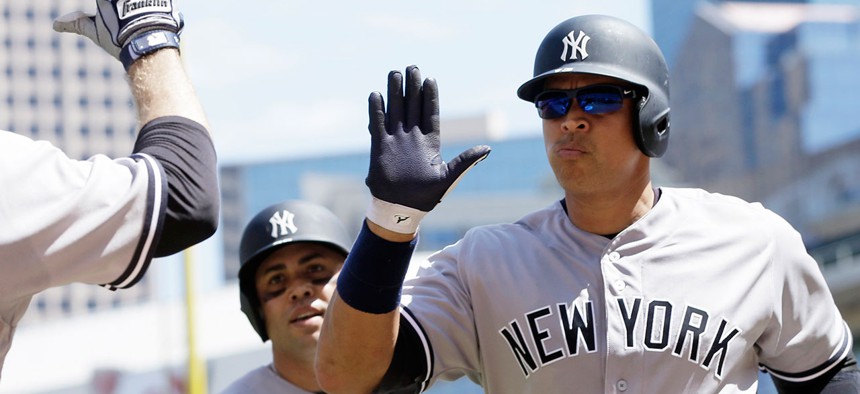 Alex Rodriguez gives teammates high fives in 2016.