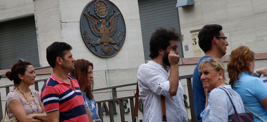 People wait to enter the visa section of the United States consulate building in Istanbul in 2015.