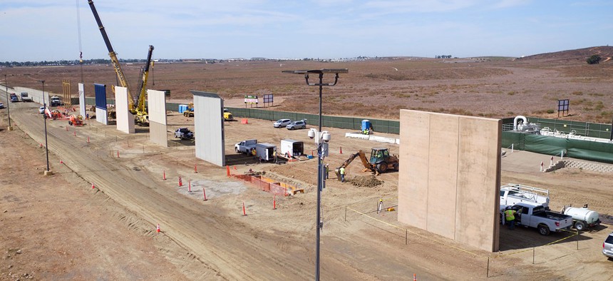 Construction crews prepare a set of border wall prototypes along the U.S. border with Mexico in October.