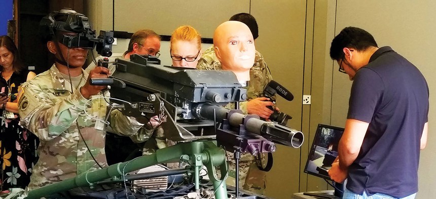 Sgt. 1st Class Taikeila Dale uses the Mk-19 simulator with augmented reality head-mounted display in August.
