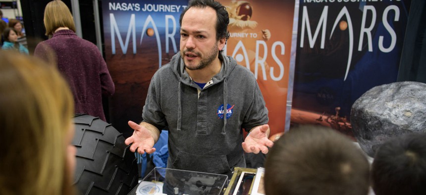 A NASA employee discusses the Mars Science Laboratory mission at the USA Science and Engineering Festival on April 6. 