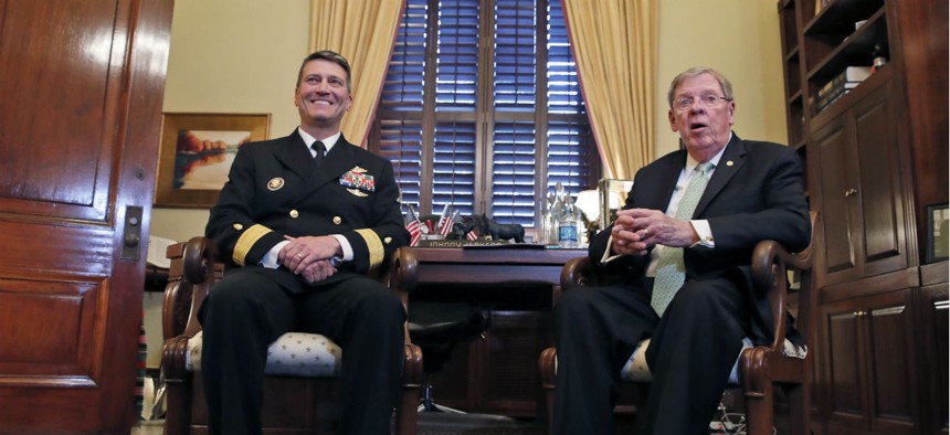 Navy Rear Adm. Ronny Jackson, M.D., left, sits with Sen. Johnny Isakson, R-Ga., chairman of the Veteran's Affairs Committee, before their meeting on April 16.