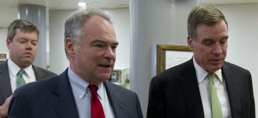 Virginia Democratic Sens. Tim Kaine (left) and Mark Warner walk to the Senate floor earlier this year. 