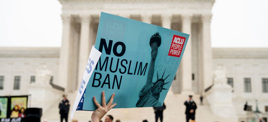 A person holds a sign during a rally at the Supreme Court building on Wednesday.