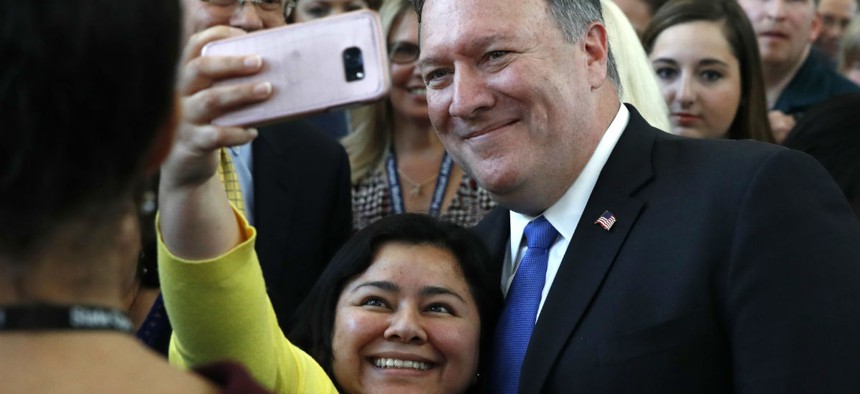 New State Department Secretary Mike Pompeo takes a selfie with an employee after his speech Tuesday. 