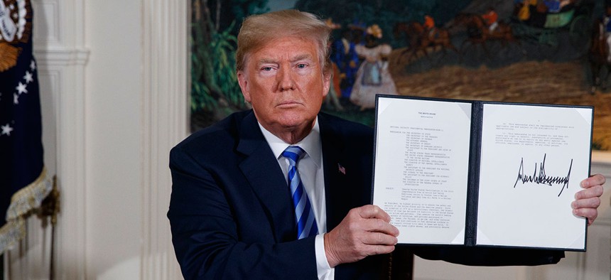 President Donald Trump shows a signed Presidential Memorandum after delivering a statement on the Iran nuclear deal on Tuesday.