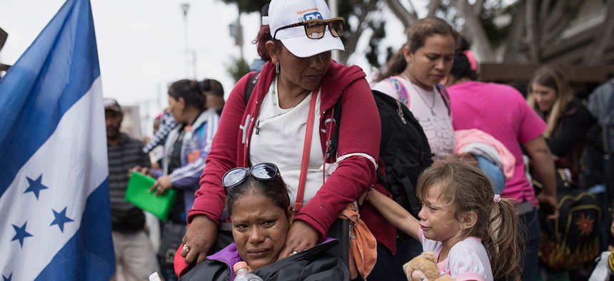 Members of a Central American family traveling with a caravan of migrants prepare to cross the border and apply for asylum in the United States in Tijuana in April.