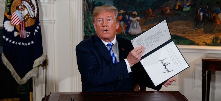 President Donald Trump signs a Presidential Memorandum on the Iran nuclear deal from the Diplomatic Reception Room of the White House on May 8.