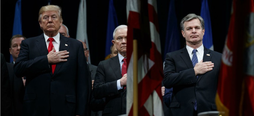 President Trump, Attorney General Jeff Sessions, and FBI Director Christopher Wray stand for the national anthem during the FBI National Academy graduation ceremony Dec. 15, 2017, in Quantico, Va.