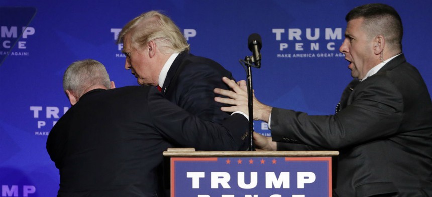 Secret Service agents take Trump off the stage during a campaign rally in Nevada. 