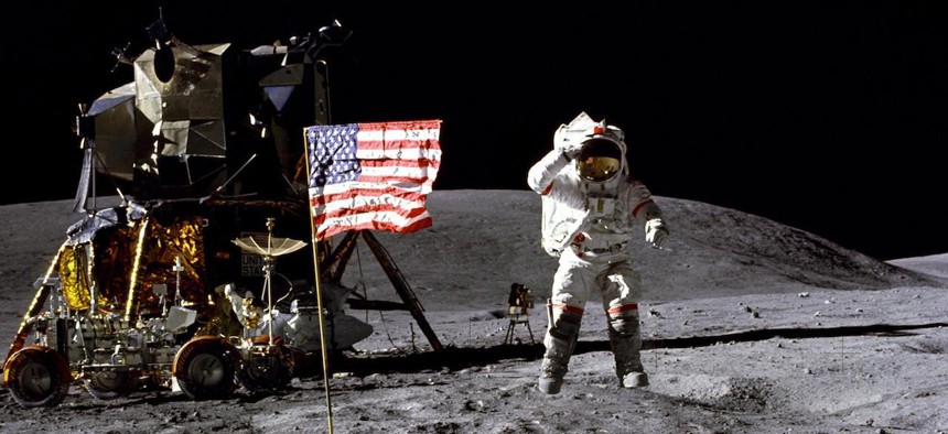 Astronaut John W. Young, commander of the Apollo 16 lunar landing mission, leaps from the lunar surface as he salutes the United States flag at the Descartes landing site during the first Apollo 16 extravehicular activity. 