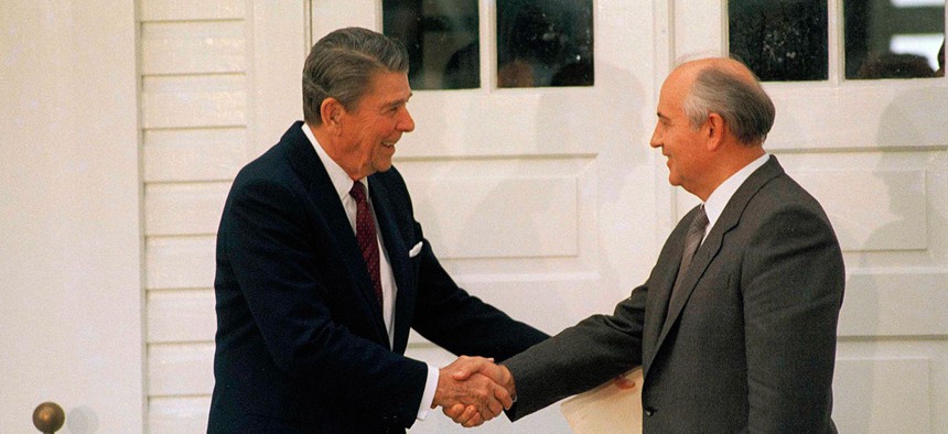 Ronald Reagan and Mikhail Gorbachev shake hands as they leave the Hofdi, in Reykjavik, after their third session of talks on October 12, 1986.