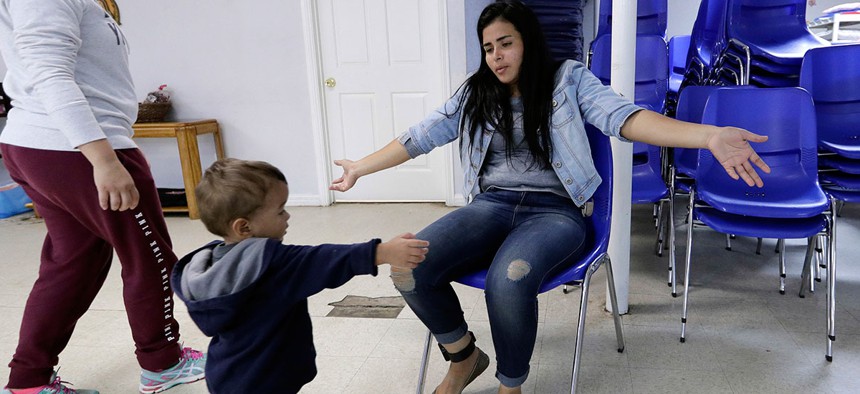 Jennifer Chevarria, from Nicaragua, opens her arms for son, Jayden, 2, at the Catholic Charities RGV Thursday, June 21, 2018, in McAllen, Texas. The family was processed and released by CBP Tuesday and are waiting to travel to relatives in California .