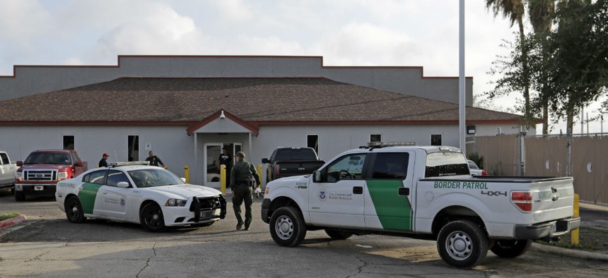 A Border Patrol Agent walks outside the Central Processing Center in McAllen, Texas. 