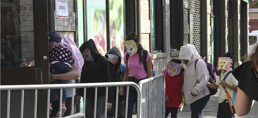 Immigrant children separated from parents who were detained at the U.S./Mexico border arrive at a foster care facility in East Harlem, N.Y., wearing masks on June 22.