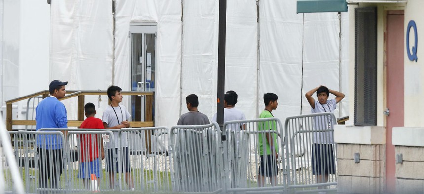 Immigrant children walk outside the Homestead Temporary Shelter for Unaccompanied Children in Florida. 