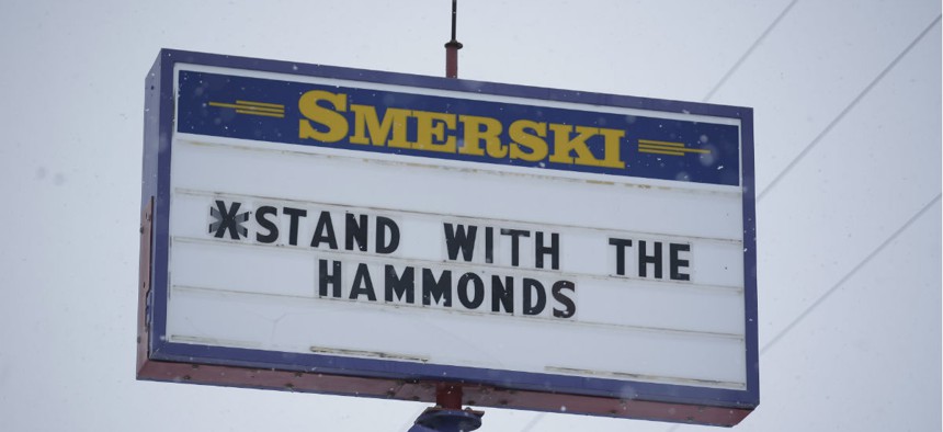 In this Jan. 5, 2016, photo, a sign in Burns, Ore., shows local support for Dwight and Steven Hammond after they were sentenced to 5 years in prison for setting fires on federal land.  