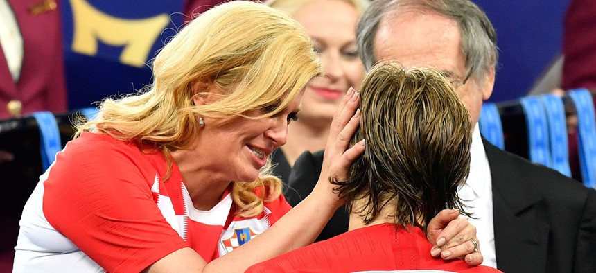 Croatian President Kolinda Grabar-Kitarović hugs Croatia's Luka Modrić after France won the final match between France and Croatia at the 2018 soccer World Cup.