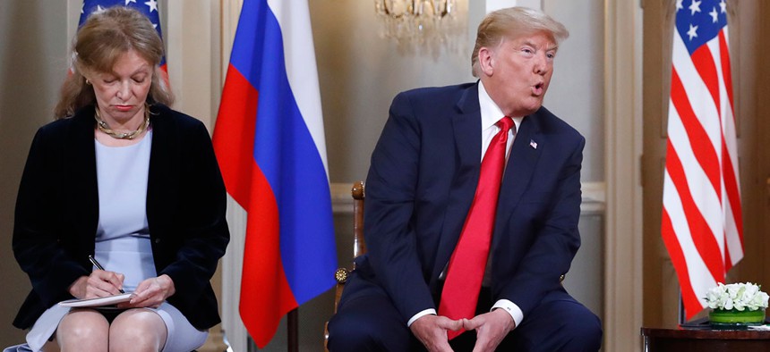 Marina Gross, left, takes notes when Trump talks to Putin in Helsinki.