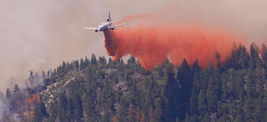 Fighting wildfires with air tankers, like this one dropping fire retardant on the Willow Fire in California on September 2, 2015, is expensive and not always effective.
